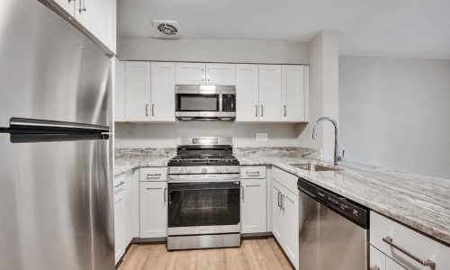 kitchen with ample counter-space, modern appliances and bright lighting
