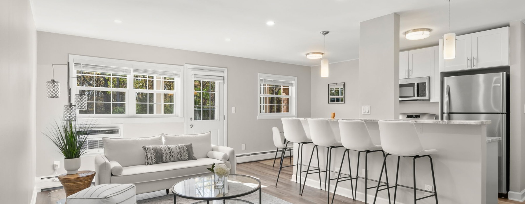 living room with seating plant and kitchen