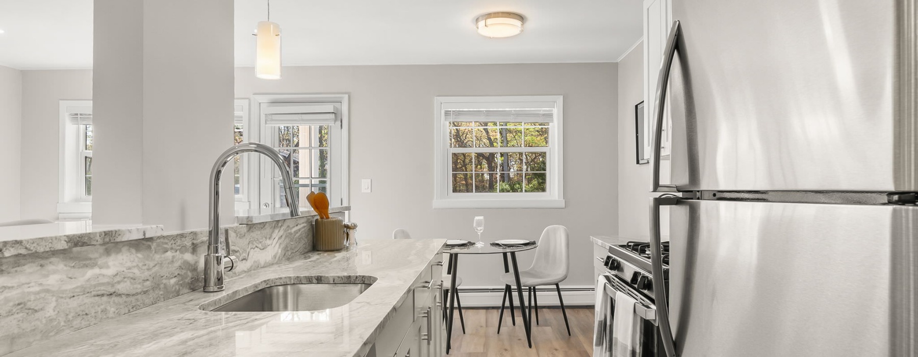 kitchen with stainless steel appliances and dining room in view